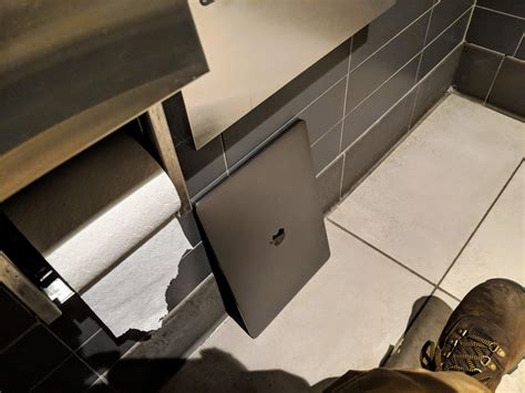 pooping in a laptop and closing it|touching laptop while in toilet.